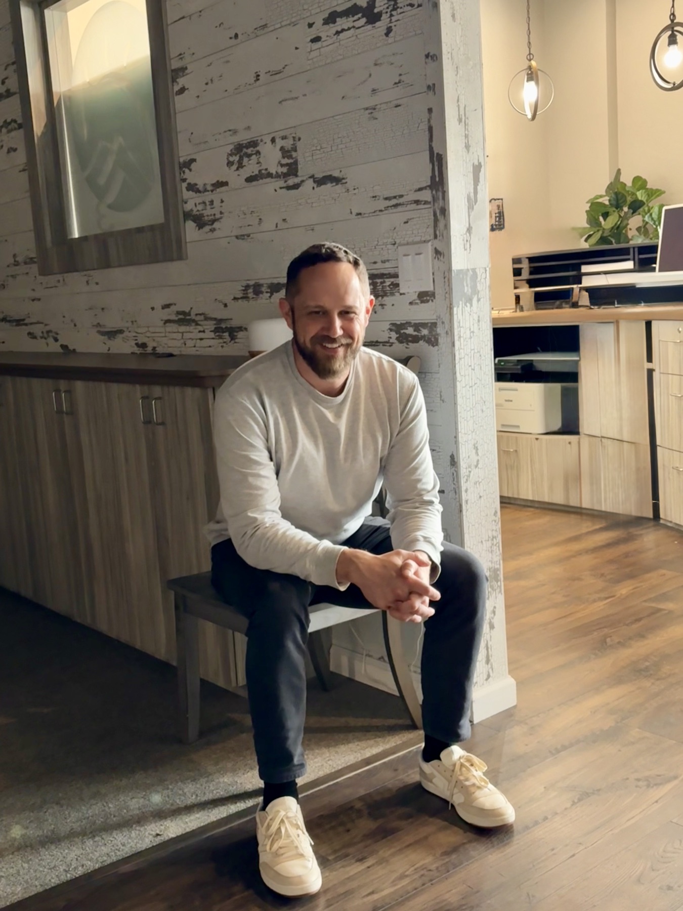 Tyler Bradshaw, founder of Trinity River AI, seated in a workspace